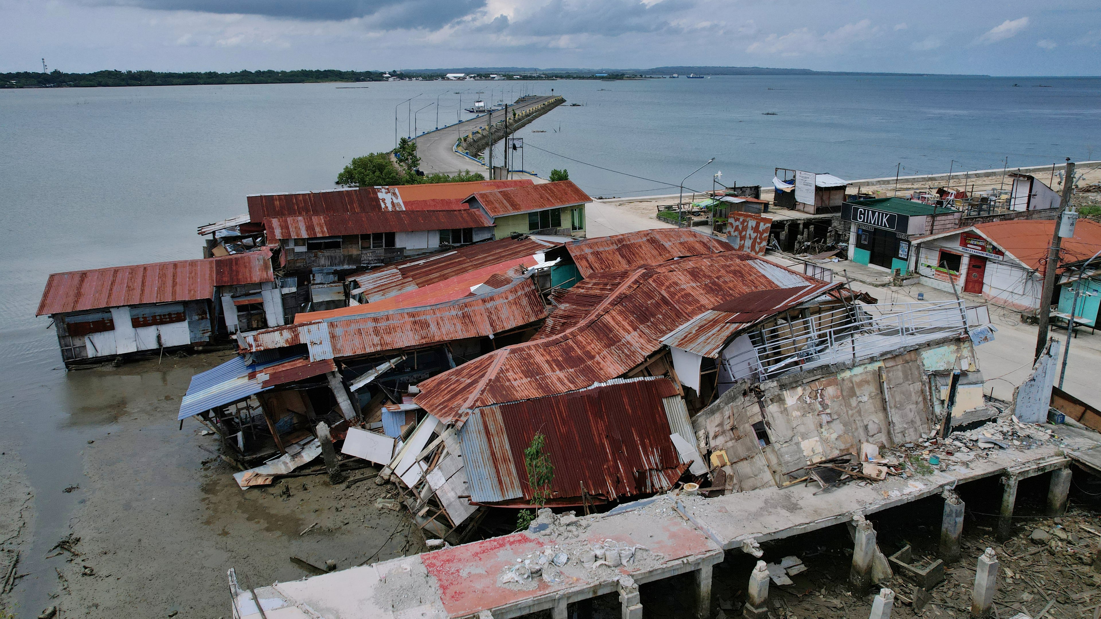 Business establishments that were damaged due to a recent strong earthquake lie at the Bogo city pier, Cebu Province, Central Philippines on Friday, Oct. 3, 2025. (AP Photo/Aaron Favila)