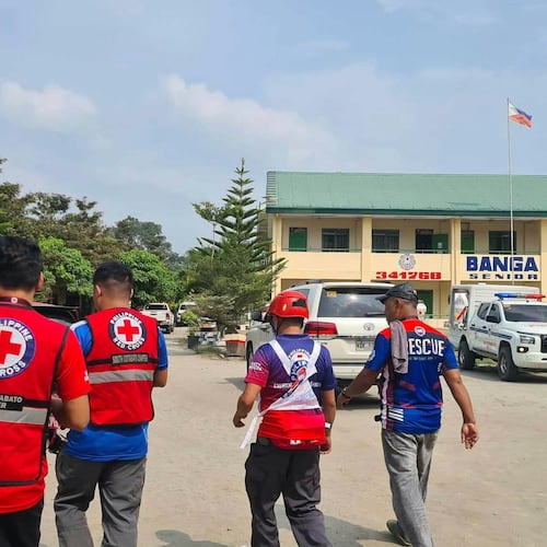 In this handout photo provided by the Philippine Red Cross, Red Cross members arrive at Banga National High School in the town of Banga, Philippines, Friday, Sept. 18, 2026. (Philippine Red Cross via AP)