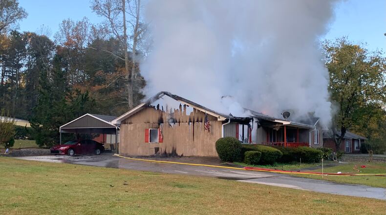 One woman was pulled from the home by neighbors but died at the scene, while a second woman was found inside.