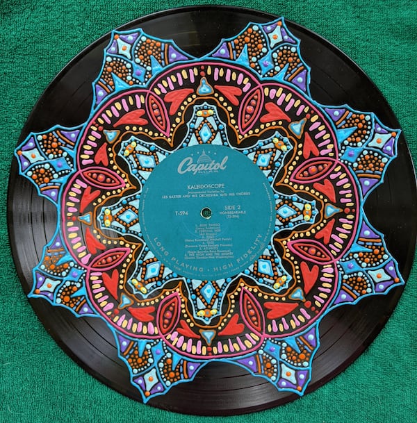 Before the pandemic, Claire Brightly Vohman of Cumming sold her paintings on vinyl records at consignment shops. Now they're available on the Viral Art Facebook page. 
Courtesy of Claire Brightly Vohman