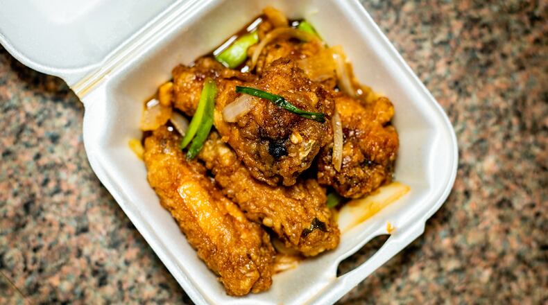 The fish sauce chicken wings from Anh's Kitchen in Midtown can be addictive. Henri Hollis for The Atlanta Journal-Constitution.