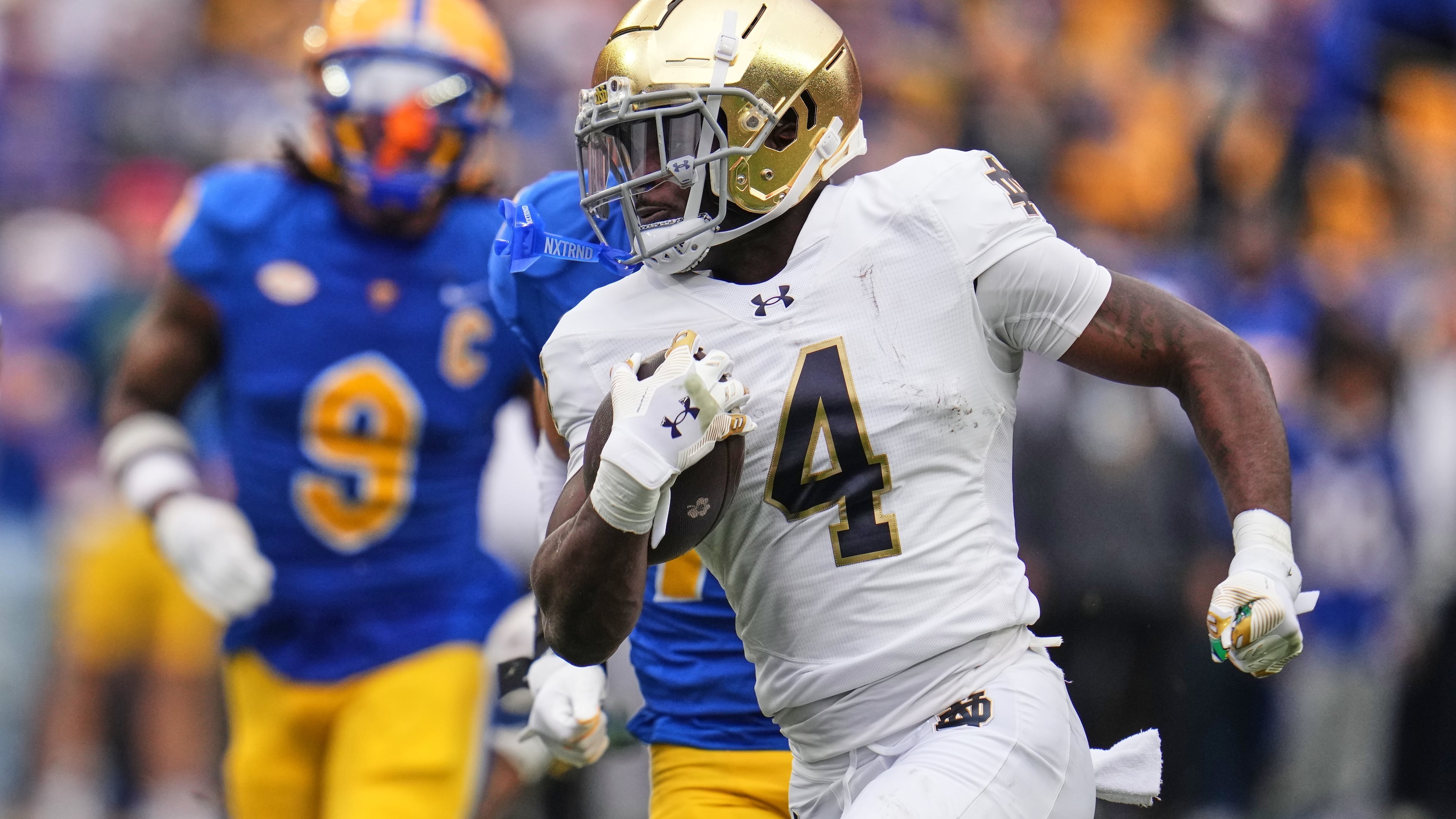 Notre Dame running back Jeremiyah Love (4) gets past Pittsburgh linebacker Kyle Louis (9) en route to a 65-yard touchdown run during the first half of an NCAA college football game in Pittsburgh, Saturday, Nov. 15, 2025. (AP Photo/Gene J. Puskar)