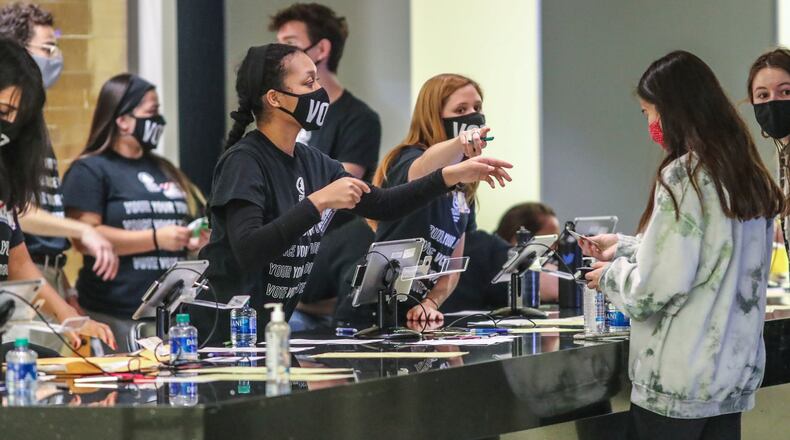 Poll workers check in voters at McCamish Pavilion at Georgia Tech in Atlanta on Tuesday, Nov. 3, 2020. (John Spink / John.Spink@ajc.com)