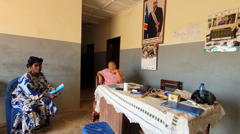 Parents who came for their children's school resumption sit inside an office of a school in Ituri province, eastern Congo, Thursday, Aug. 27, 2026. (AP Photo/Constant Same Bagalwa)