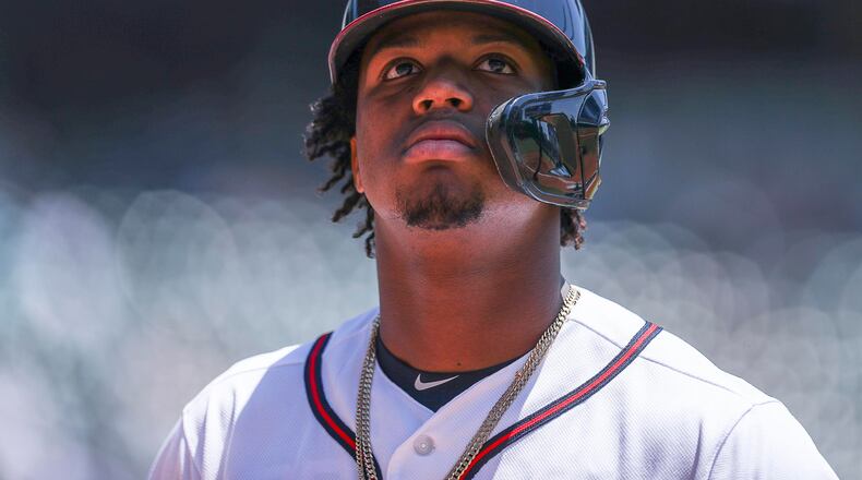 Braves left fielder Ronald Acuna Jr.  looks toward the stands as he heads to the dugout in a recent game. (ALYSSA POINTER/ALYSSA.POINTER@AJC.COM)