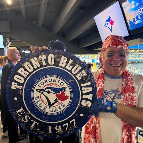 Toronto Blue Jays fan Geoffrey Fulton poses with his Blue Jays gear and maple leaf bandana during Game 7 of baseball's American League Championship Series between the Blue Jays and Seattle Mariners in Toronto, Monday, Oct. 20, 2025. (AP Photo/Rob Gillies)