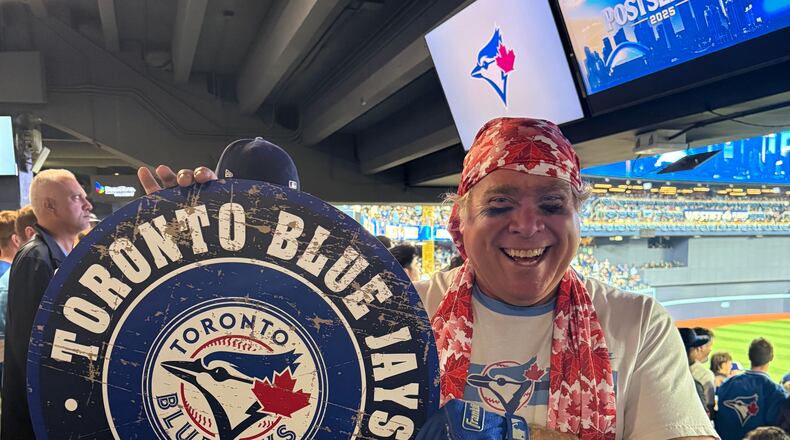 Toronto Blue Jays fan Geoffrey Fulton poses with his Blue Jays gear and maple leaf bandana during Game 7 of baseball's American League Championship Series between the Blue Jays and Seattle Mariners in Toronto, Monday, Oct. 20, 2025. (AP Photo/Rob Gillies)