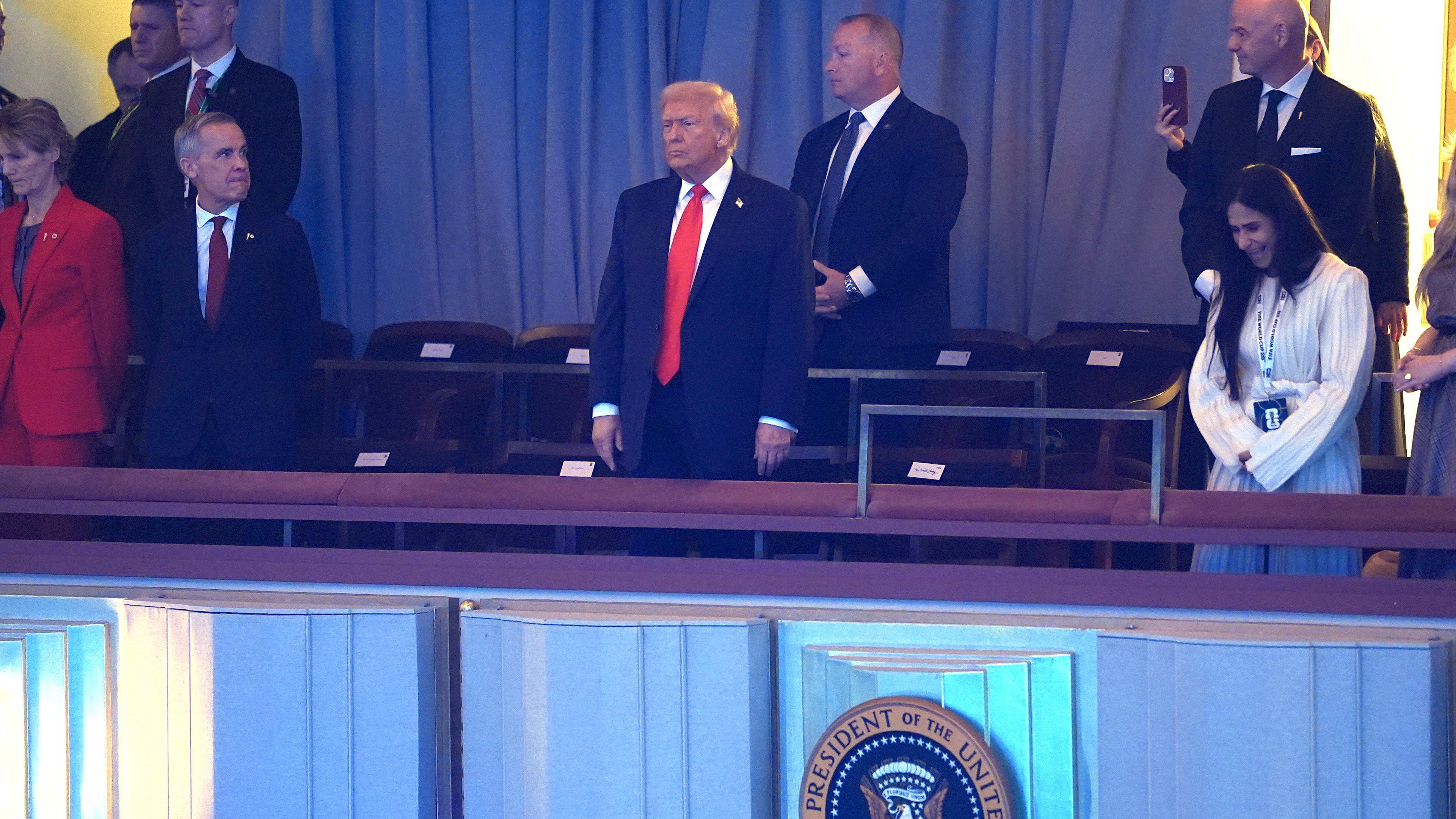 President Donald Trump stands suring his arrival at the Kennedy Center for the 2026 FIFA World Cup draw, Friday, Dec. 5, 2025, in Washington. (AP Photo/Evan Vucci)