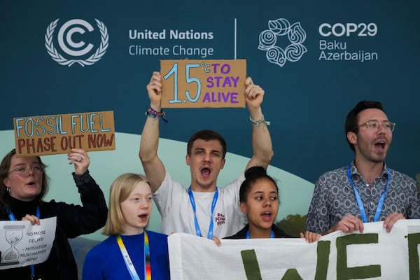 FILE - Activists participate in a demonstration for phasing out fossil fuels at the COP29 U.N. Climate Summit, Nov. 19, 2024, in Baku, Azerbaijan. (AP Photo/Sergei Grits, File)