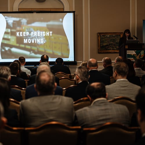 People watch an introductory short film about the proposed merger between Union Pacific and Norfolk Southern during the Railway Age’s Next-Gen Freight Rail conference on Tuesday, March 10, 2026, in Chicago. The merger could be leveraged by state and local leaders to kick-start the replacement of outmoded urban infrastructure, guest columnist Jeff Rader writes. (Jamie Kelter Davis for the AJC)