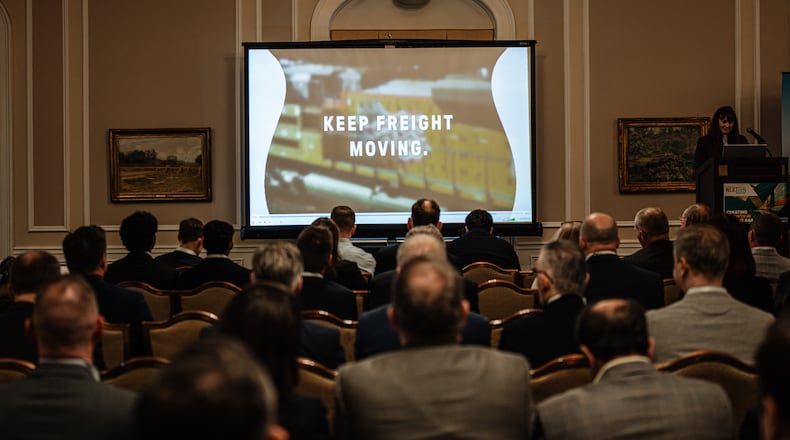 People watch an introductory short film about the proposed merger between Union Pacific and Norfolk Southern during the Railway Age’s Next-Gen Freight Rail conference on Tuesday, March 10, 2026, in Chicago. The merger could be leveraged by state and local leaders to kick-start the replacement of outmoded urban infrastructure, guest columnist Jeff Rader writes. (Jamie Kelter Davis for the AJC)