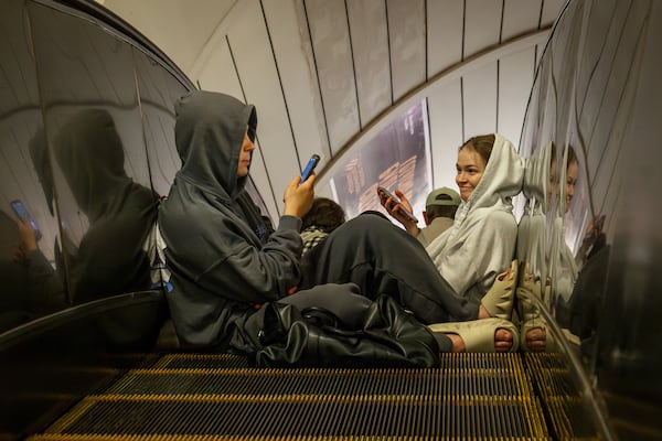 People rest in a metro station, being used as a bomb shelter, during a Russian drones attack in Kyiv, Ukraine, early Tuesday, June 10, 2025. (AP Photo/Dan Bashakov)