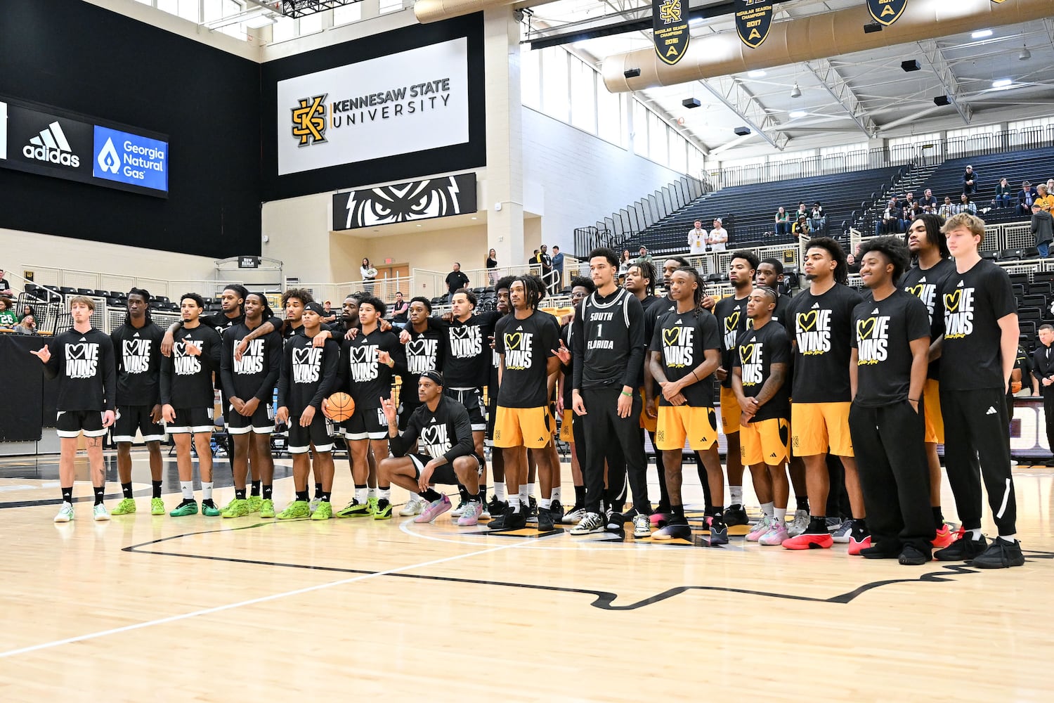 South Florida and Kennesaw State players wear shirts with the slogan “Love Wins” to honor the legacy of Amir Abdur-Rahim, a former KSU coach, during their game Sunday, Nov. 16, 2025 at Kennesaw State University. (Daniel Varnado for the AJC)