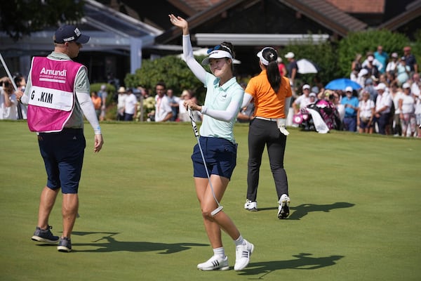 Grace Kim, of Australia, celebrates after winning the Evian Championship women's golf tournament, in Evian, eastern France, Sunday, July 13, 2025. (AP Photo/Laurent Cipriani)