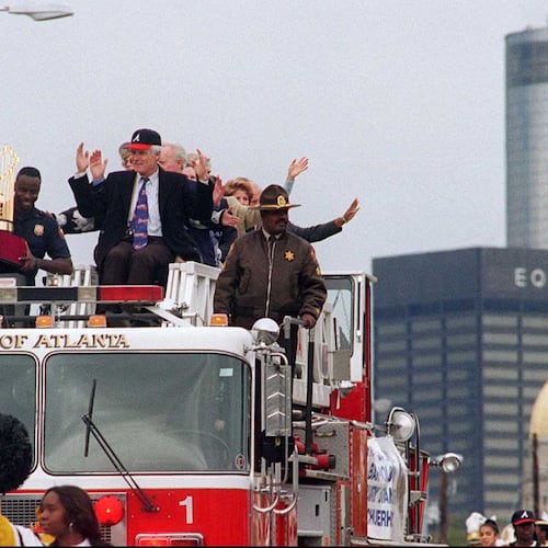 Atlanta Braves owner Ted Turner makes the symbolic tomahawk chop from a fire engine Monday, October 30, 1995, as the Braves victory parade passes the state Capitol. (AJC photo/Johnny Crawford)