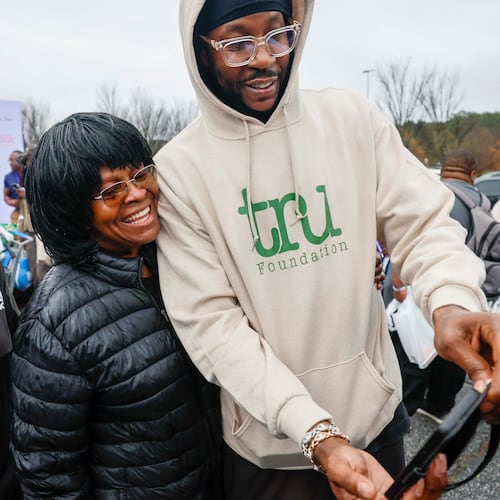 American rapper and actor 2 Chainz takes a selfie with Rachel Fortson of Decatur during the “Greens and Things" Thanksgiving giveaway event on Tuesday, Nov. 24, 2025. 2 Chainz teamed up with Walmart to help 150 families through the food giveaway in College Park. (Miguel Martinez/AJC)