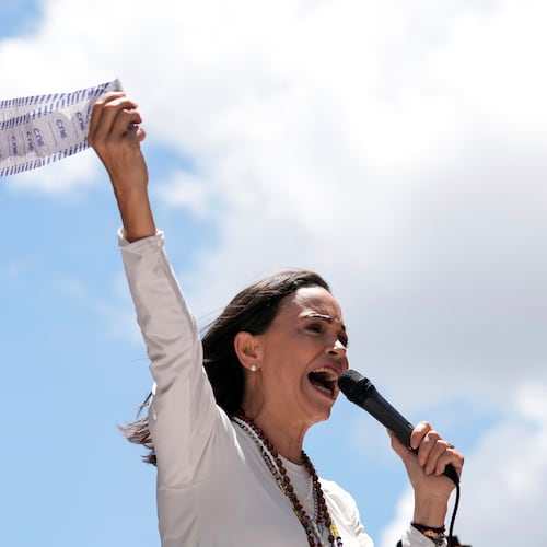 FILE - Opposition leader Maria Corina Machado displays vote tally sheets during a protest against the reelection of President Nicolas Maduro one month after the disputed presidential vote which she says the opposition won by a landslide, in Caracas, Venezuela, Wednesday, Aug. 28, 2024. (AP Photo/Ariana Cubillos, file)