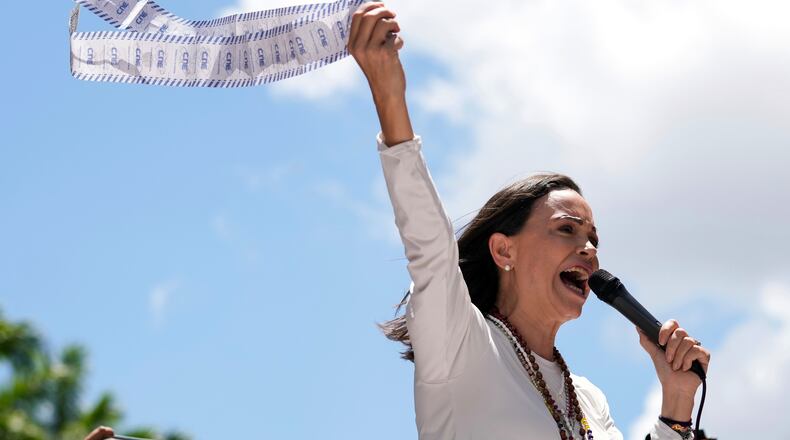 FILE - Opposition leader Maria Corina Machado displays vote tally sheets during a protest against the reelection of President Nicolas Maduro one month after the disputed presidential vote which she says the opposition won by a landslide, in Caracas, Venezuela, Wednesday, Aug. 28, 2024. (AP Photo/Ariana Cubillos, file)