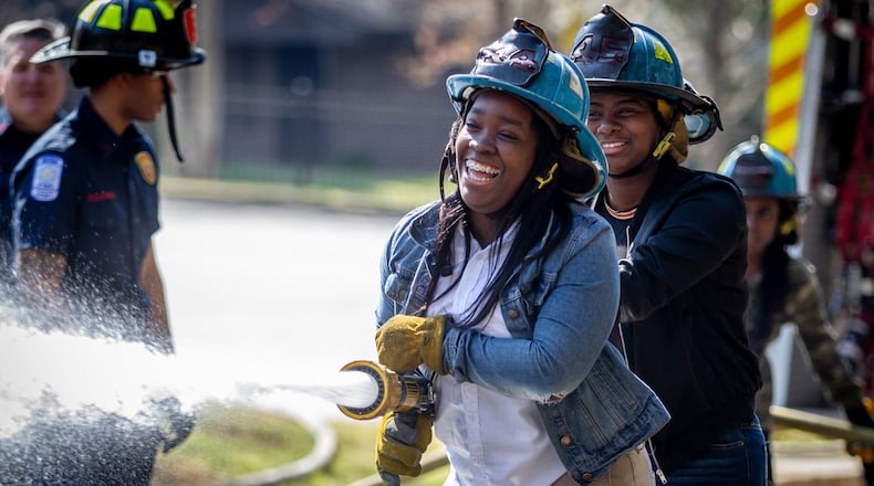 Therrell High School senior Dayssia Dugger (C) participates in the Atlanta Fire departments Delayed Entry Program training at her high school Thursday, March 21, 2019.  STEVE SCHAEFER / SPECIAL TO THE AJC