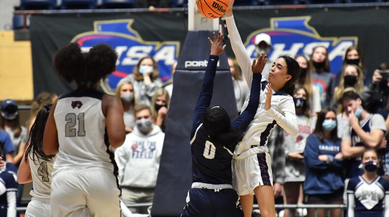 March 13, 2021 Macon - Woodstock's Savannah Casey (right) blocks a shot by Marietta's Loren Nelson (0) during the 2021 GHSA State Basketball Class AAAAAAA Girls Championship game at the Macon Centreplex in Macon on Saturday, March 13, 2021 Marietta won 52-47 over Woodstock. (Hyosub Shin / Hyosub.Shin@ajc.com)