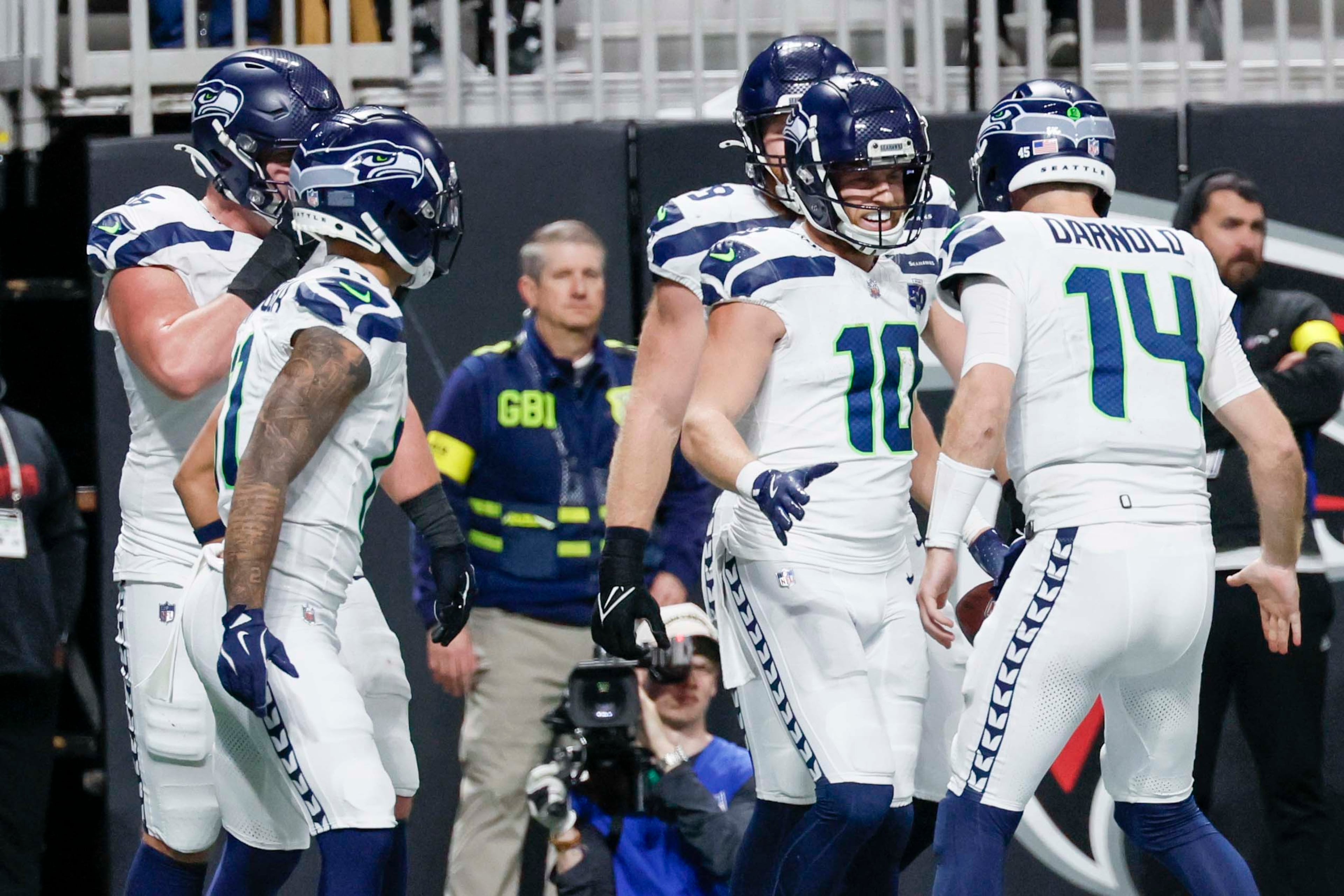 Seattle Seahawks wide receiver Cooper Kupp (10) celebrates with Seattle Seahawks quarterback Sam Darnold (14) after scoring a touchdown during the second half of an NFL game against the Atlanta Falcons at Mercedes-Benz Stadium in Atlanta on Sunday, Dec. 7, 2025. (Miguel Martinez/ AJC)