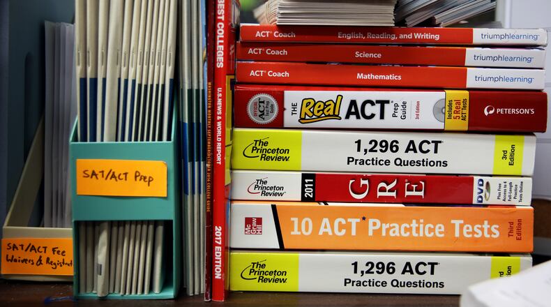 FILE ACT and GRE prep books are stacked in a guidance counselors office at Hobbton High School in Sampson County, N.C., May 19, 2017. Instead of just helping disadvantaged students to catch up with peers, educators are looking for ways to give them more chances to shine in advanced classes and selective schools. (Travis Dove/The New York Times)