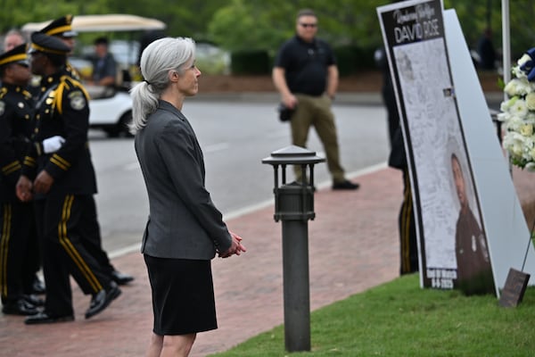 CDC Director Susan Monarez visits the memorial for DeKalb County police Officer David Rose, who was killed while responding to the Aug. 8 shooting at the CDC. (Hyosub Shin/AJC)