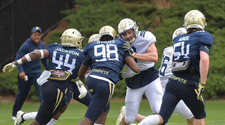 Georgia Tech defensive lineman Curtis Ryans (98) and Georgia Tech tight end Tyler Davis (9) battle during a practice session Thursday, April 18, 2019, at Georgia Tech's football outdoor practice field in Atlanta.