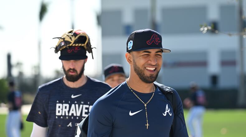 Braves left fielder Eddie Rosario smiles as he walks to the baseball field for batting practice during Braves spring training at CoolToday Park, Saturday, Feb. 18, 2023, in North Port, Fla.. (Hyosub Shin / Hyosub.Shin@ajc.com)