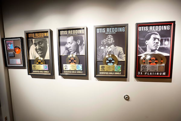 Framed photos of the legendary soul singer hang on along a wall of the Otis Redding Center for the Arts in Macon. (Miguel Martinez/AJC)