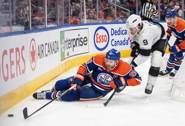 Los Angeles Kings' Adrian Kempe (9) trips up Edmonton Oilers' Leon Draisaitl (29) during the second period of an NHL playoff game in Edmonton on Sunday, April 27, 2025. (Jason Franson/The Canadian Press via AP)