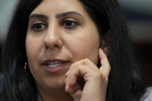 FILE - Florida Rep. Anna Eskamani talks with a colleague at the end of a meeting of the House Economic Infrastructure Subcommittee during a legislative session at the state Capitol in Tallahassee, Fla., March 5, 2025. (AP Photo/Rebecca Blackwell, File)