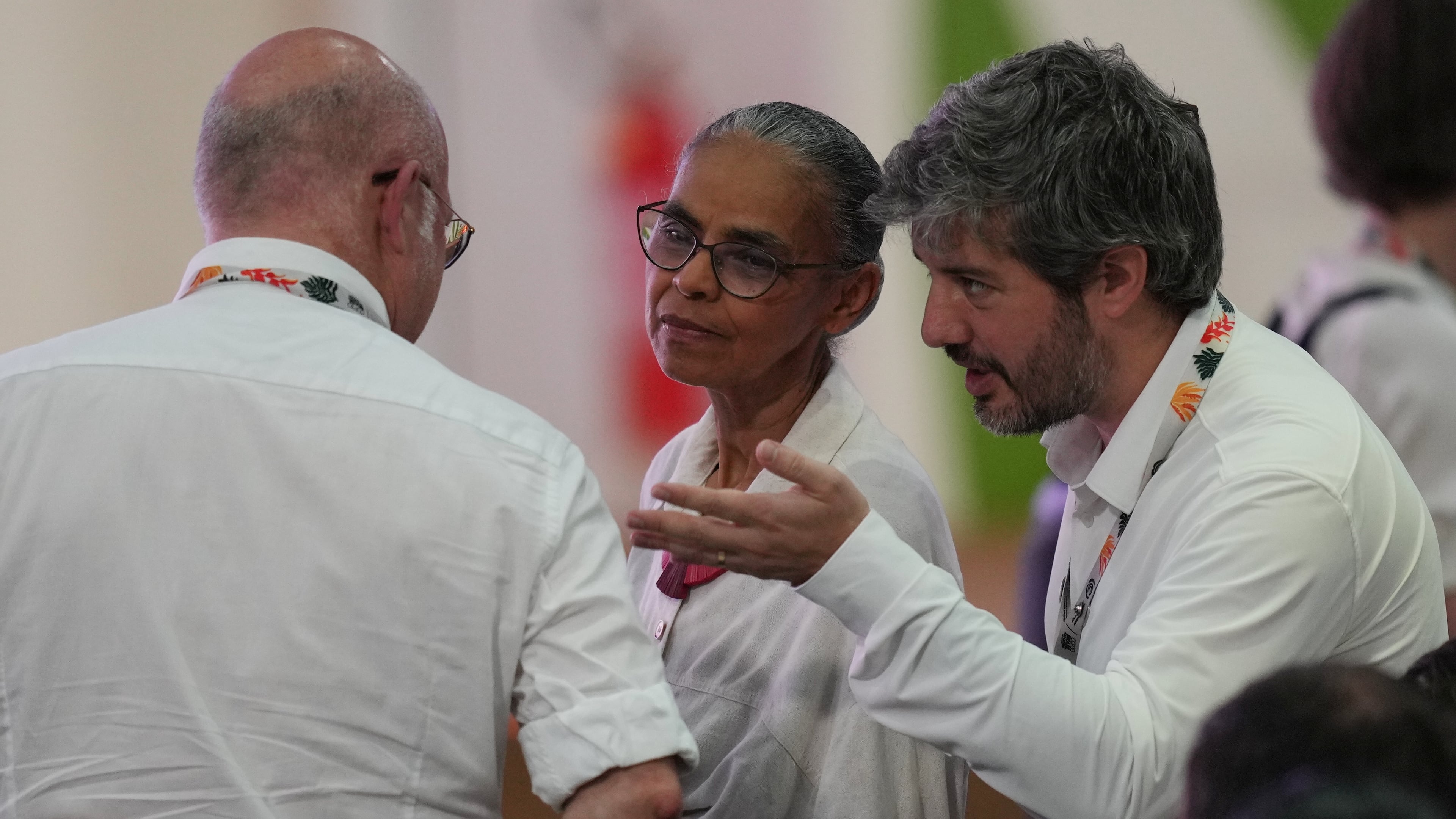 Marina Silva, Brazil environment minister, center, speaks with delegates as she waits for the start of a plenary session at the COP30 U.N. Climate Summit, Saturday, Nov. 22, 2025, in Belem, Brazil. (AP Photo/Andre Penner)