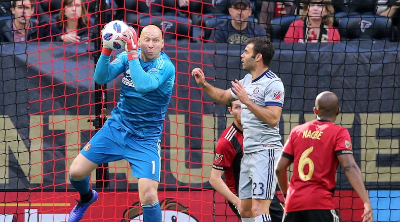Atlanta United goalkeeper Brad Guzan blocks a shot in front of Chicago Fire forward Nemanja Nikolic during the second half in a MLS soccer match on Sunday, Oct 21, 2018, in Atlanta.   Curtis Compton/ccompton@ajc.com
