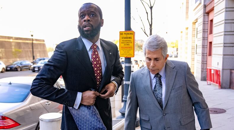 FILE - Prakazrel "Pras" Michel, a member of the 1990s hip-hop group the Fugees, accompanied by defense lawyer David Kenner, right, arrives at federal court April 3, 2023, in Washington. (AP Photo/Andrew Harnik, File)