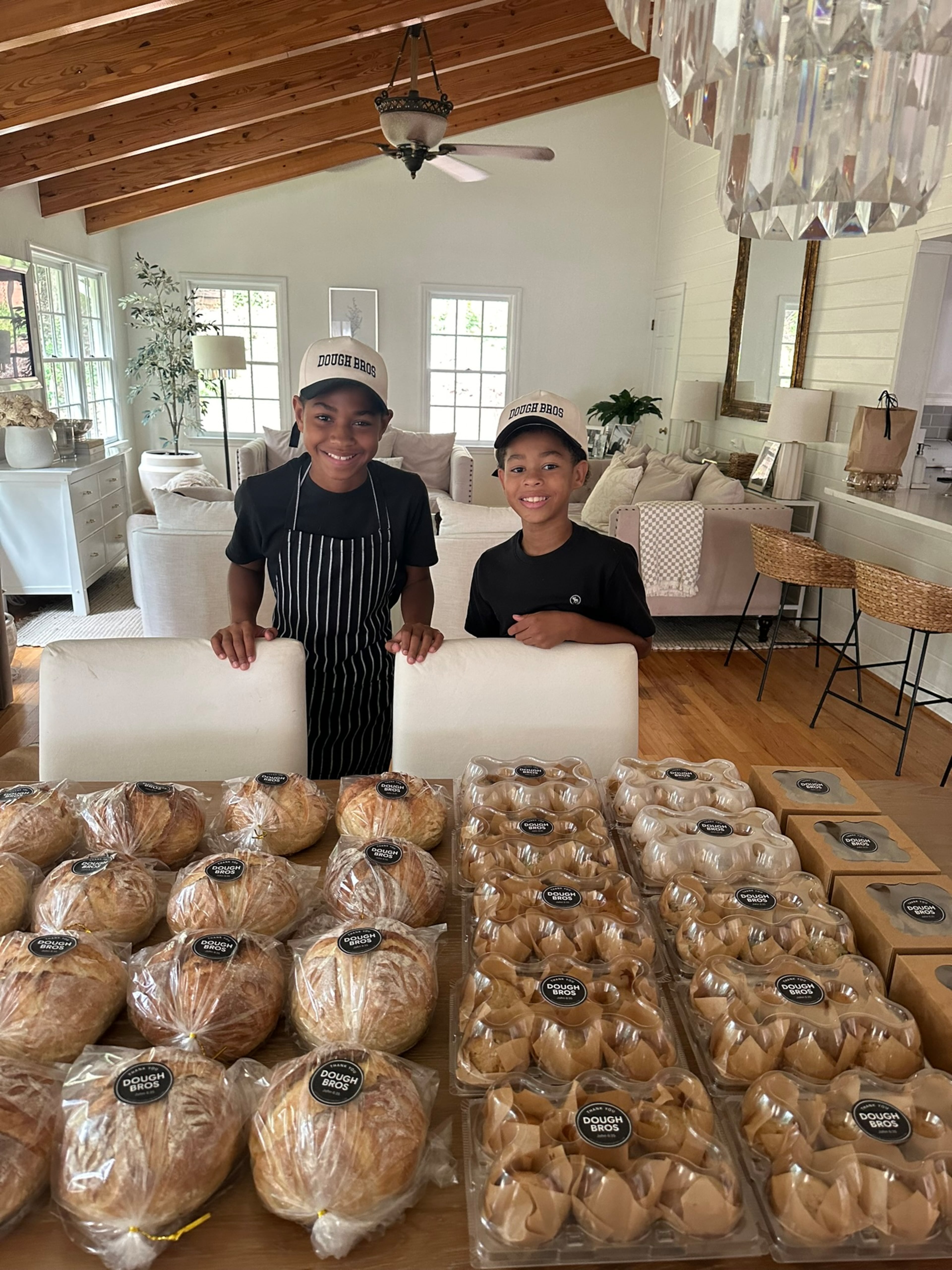 The Lampley brothers, London (left), and Leo operate their Dough Bros bakery stand every other Saturday in their neighborhood. (Courtesy of Sarah Lampley)