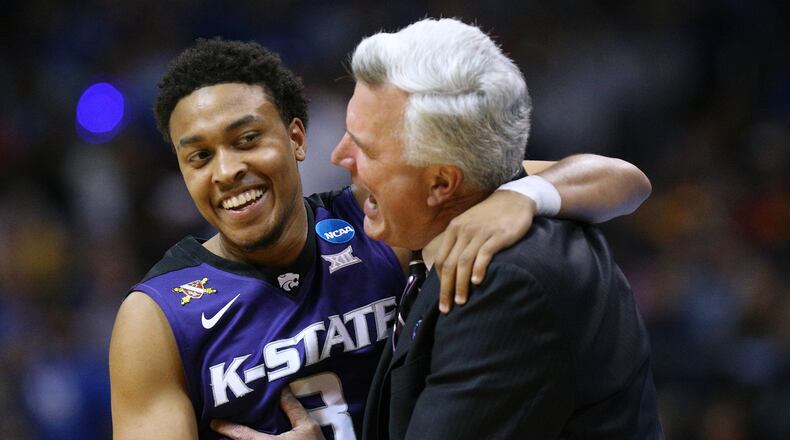 Kansas State head coach Bruce Weber hugs it out with Kamau Stokes, celebrating their upset of Kentucky. (Curtis Compton/ccompton@ajc.com)