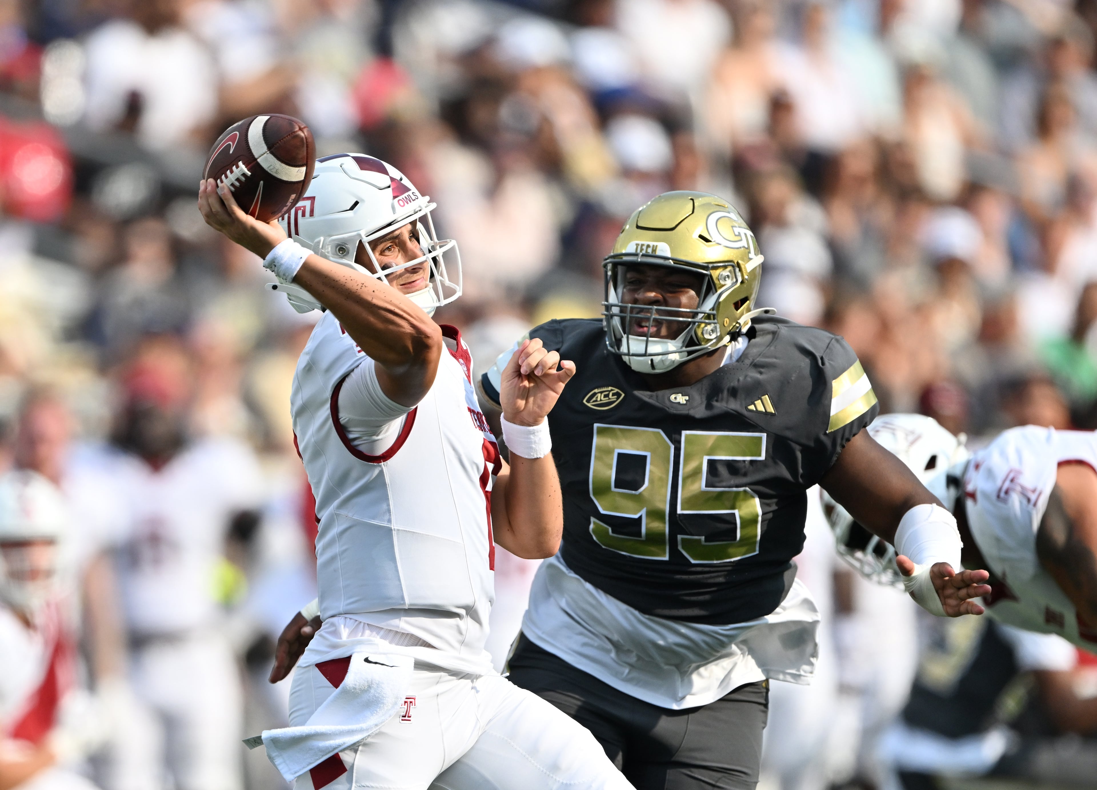 Temple quarterback Evan Simon throws under pressure from Georgia Tech defensive lineman Jason Moore during the first half of an NCAA college football game at Georgia Tech's Bobby Dodd Stadium, Saturday, Sept. 20, 2025 in Atlanta. (Hyosub Shin/AJC)