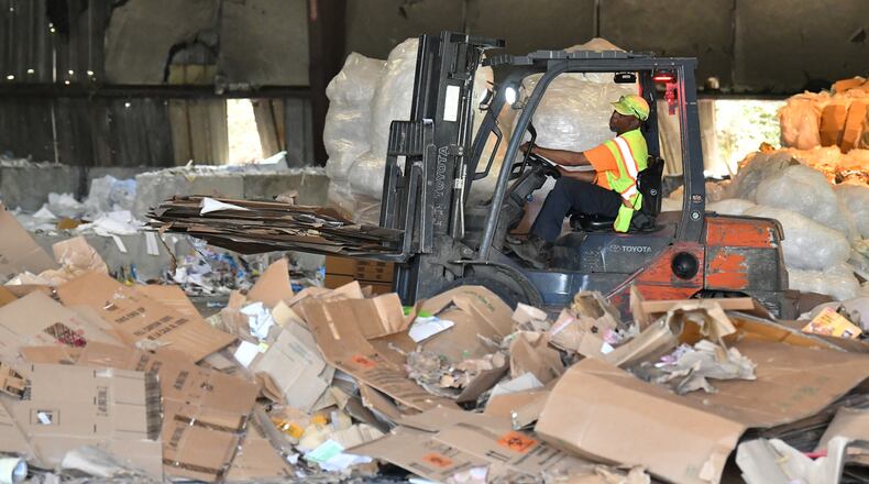 A worker operates a forklift to unload and sort cardboard boxes at Sonoco Recycling Atlanta Facility on Tuesday, April 6, 2021.  (Hyosub Shin / Hyosub.Shin@ajc.com)