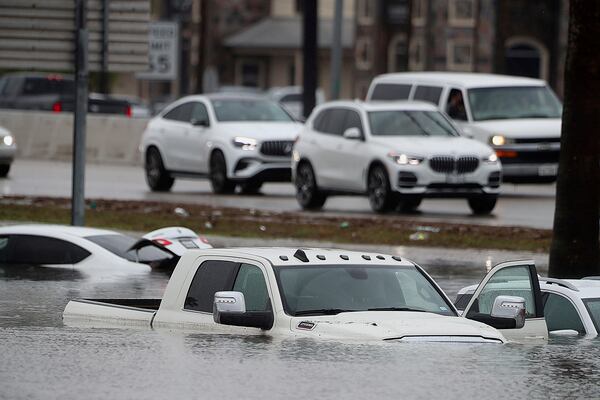 Stranded vehicles left on frontage road in front the McAllen Convention Center during a downpour on Thursday, March 27, 2025, in McAllen, Texas. (Joel Martinez /The Monitor via AP)