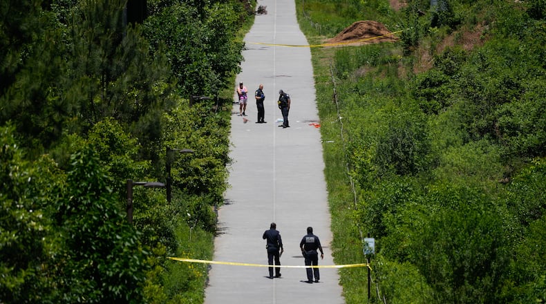 Crime scene tape blocks off a portion of the Beltline near Flagler Avenue Northeast, where Atlanta police say they are responding to a report of a person stabbed. (Ben Hendren for the AJC)