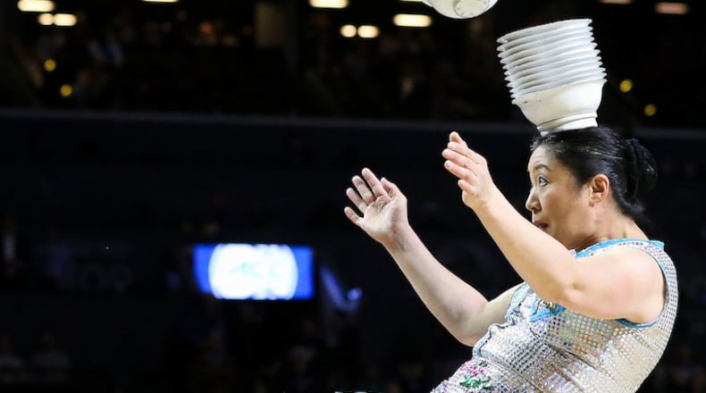 Red Panda catches bowls on her head while performing at halftime during the quarterfinals of the 2017 New York Life ACC Tournament at the Barclays Center in Brooklyn, N.Y., Thursday, March 9, 2017. (Photo by David Welker, theACC.com)