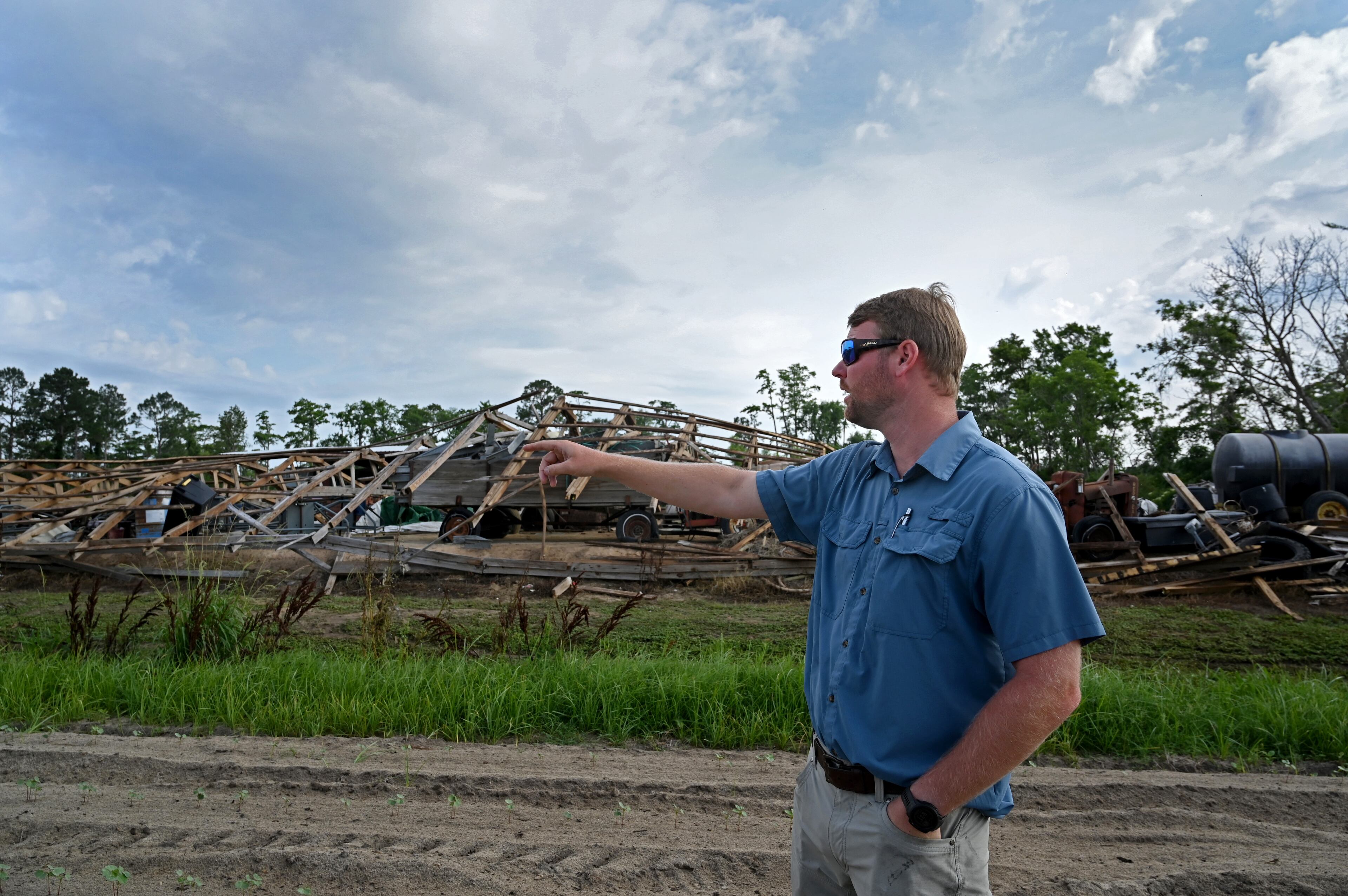 Daniel Raulerson expresses his concerns as he shows destroyed equipment structures devastated by Helene on his cotton field in Douglas. He said he lost hundreds of thousands of dollars in damaged row crops such as cotton, corn and peanuts. (Hyosub Shin/AJC)