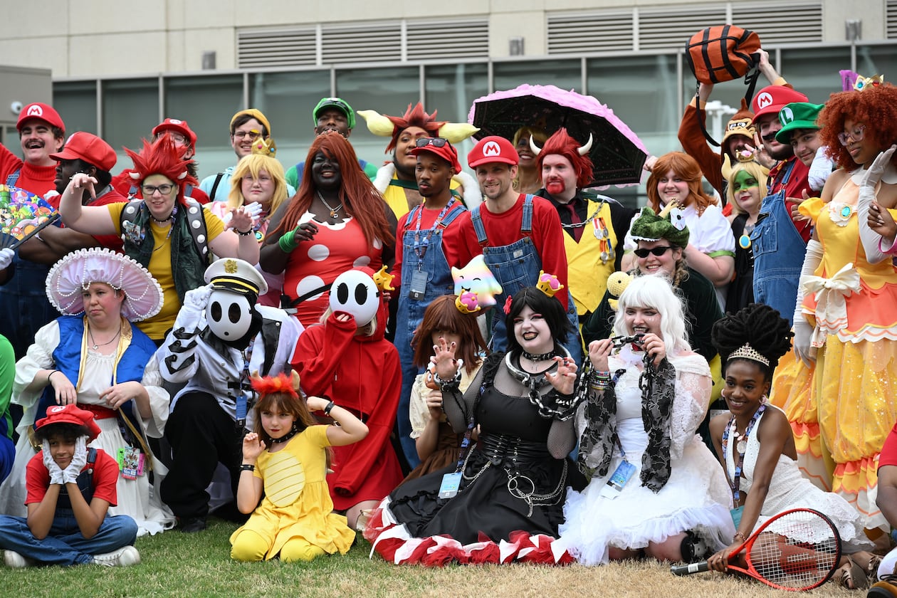 Attendees, dressed as characters from the Super Mario games, pose for a picture during MomoCon at the Georgia World Congress Center in Atlanta on Friday, May 22, 2026. (Tyler Sun for the AJC)