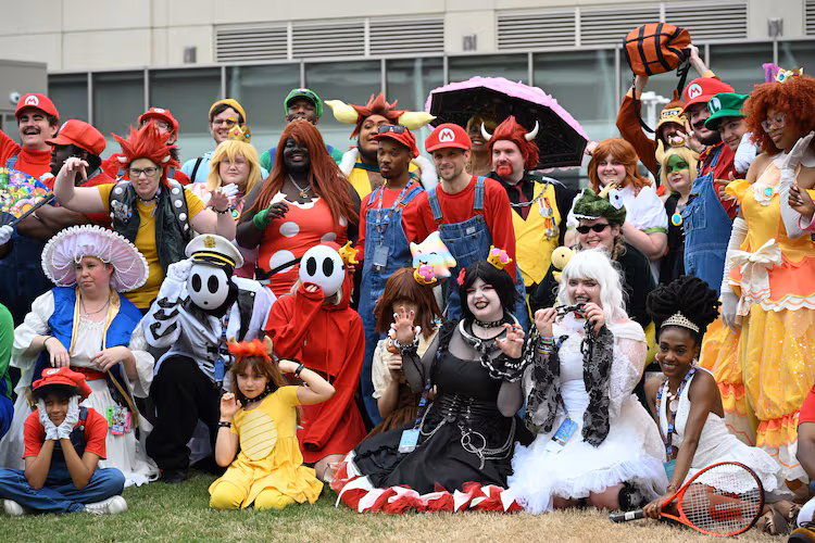 Attendees, dressed as characters from the Super Mario games, pose for a picture during MomoCon at the Georgia World Congress Center in Atlanta on Friday, May 22, 2026. (Tyler Sun for the AJC)