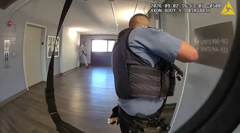 This image made from body camera video provided by the Minneapolis Police Department of a Wednesday, Sept. 2, 2026, shooting shows Minneapolis police Officer Joseph Michnowski looking down an apartment hallway as Carlton Johnson emerges with a handgun. (City of Minneapolis via AP)