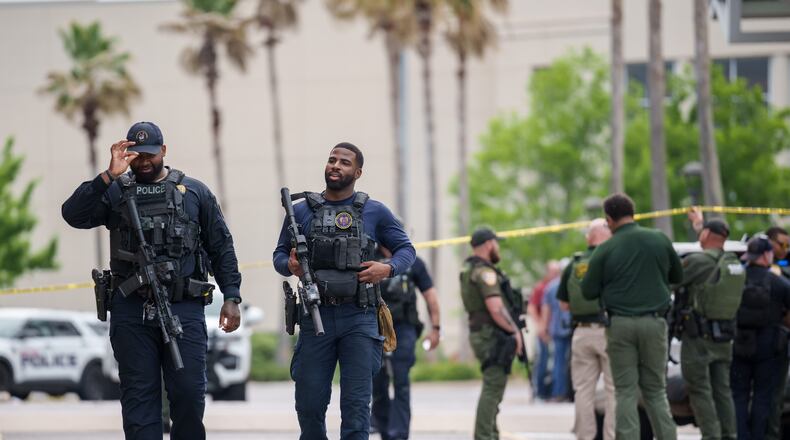 Baton Rouge police and Sheriff deputies respond to a mass shooting at the Mall of Louisiana, Thursday, April 23, 2026, in Baton Rouge, La. (AP Photo/Matthew Hinton)
