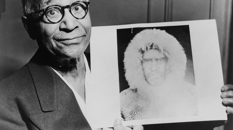 Matthew Henson, explorer, in 1953 holding a portrait of Robert E. Peary taken during an expedition to the North Pole. (World-Telegram photo by Roger Higgins / courtesy of Library of Congress)