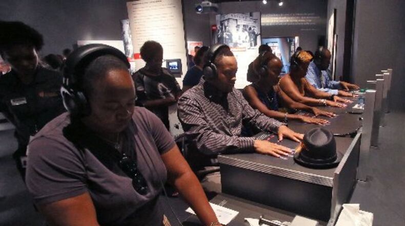 The National Center for Civil and Human Rights. First day visitors of the NCCHR at the interactive lunch counter exhibit, which recreates through an audio and visual experience what it was like to be at a lunch counter sit-in. BOB ANDRES / BANDRES@AJC.COM