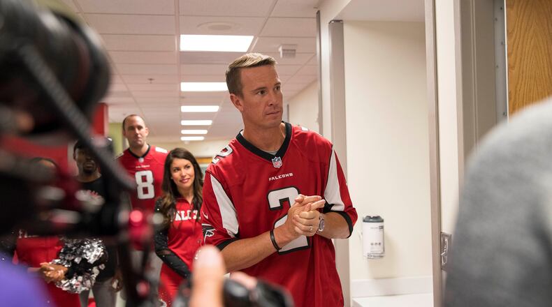 Former Atlanta Falcons quarterback Matt Ryan visits a patient at Children's Healthcare of Atlanta at Egleston in this Oct. 2018 file photo. (AJC file)
